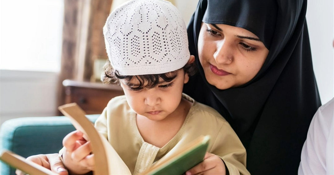 Muslim mother teaching her young son to read the Quran at home