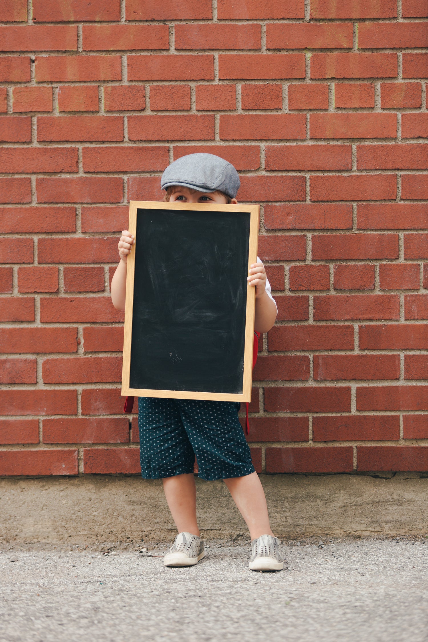 Young student holding a chalkboard
